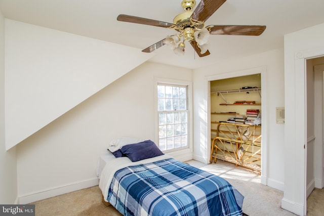 bedroom with light carpet, ceiling fan, a closet, and vaulted ceiling