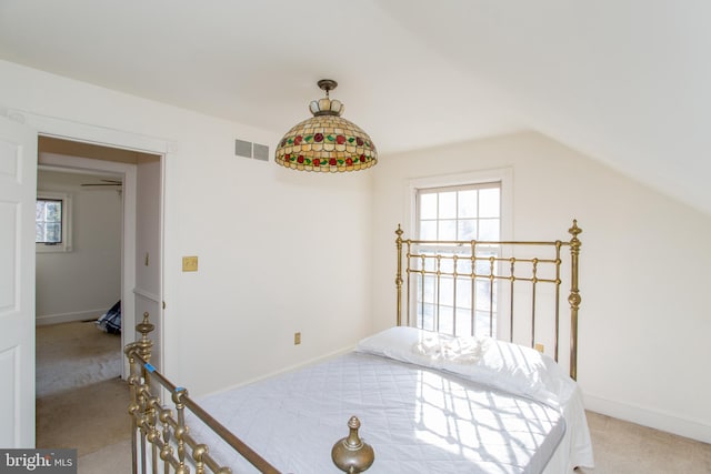 carpeted bedroom featuring lofted ceiling