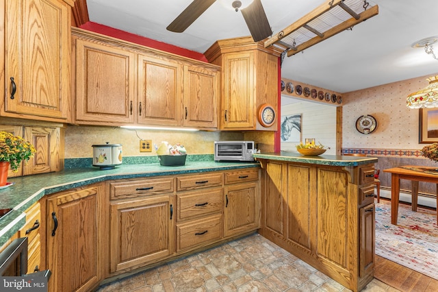 kitchen featuring ceiling fan, kitchen peninsula, and a baseboard heating unit