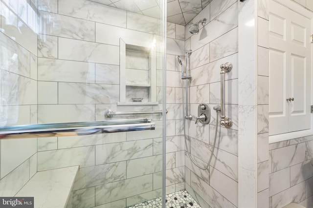 bathroom featuring a shower with shower door