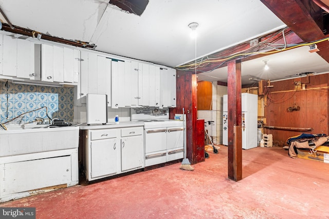 kitchen featuring white appliances and white cabinetry