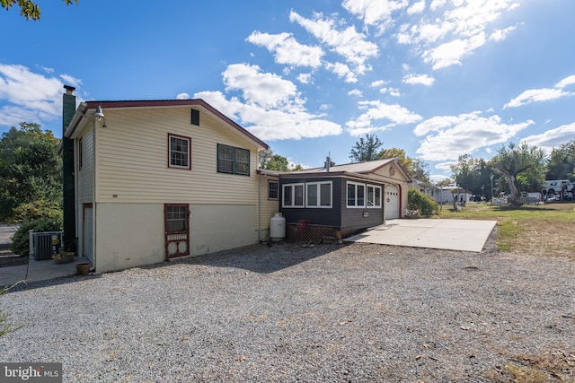 back of house featuring a patio area and central air condition unit