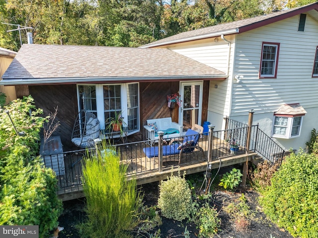 rear view of property featuring a wooden deck