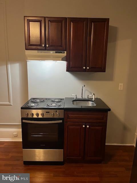 kitchen featuring sink, dark hardwood / wood-style flooring, stainless steel range with electric cooktop, and dark brown cabinets