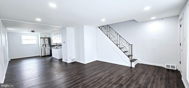 unfurnished living room with dark hardwood / wood-style floors