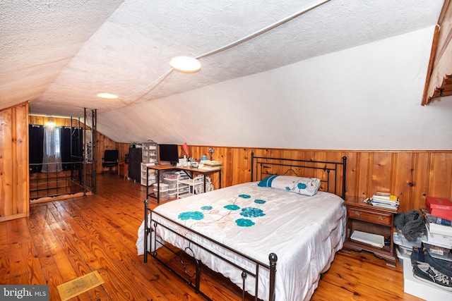 862 Bay Ave, Toms River, NJ 08753 - bedroom featuring hardwood / wood-style floors, vaulted ceiling, and a textured ceiling