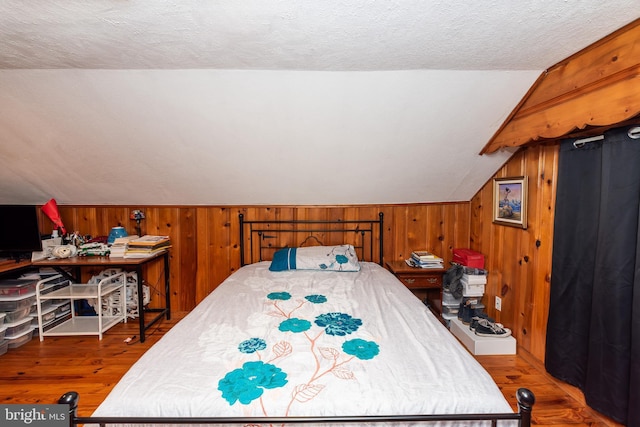 862 Bay Ave, Toms River, NJ 08753 - bedroom featuring lofted ceiling, hardwood / wood-style floors, a textured ceiling, and wood walls