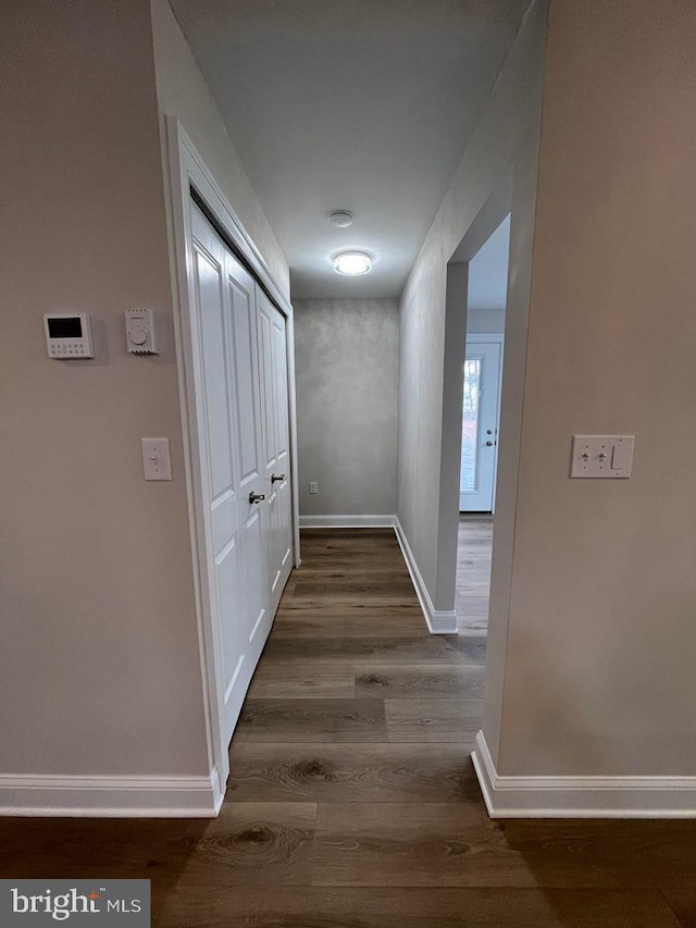 hallway with dark hardwood / wood-style floors