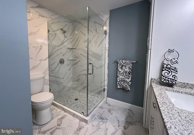 bathroom with toilet, vanity, and an enclosed shower