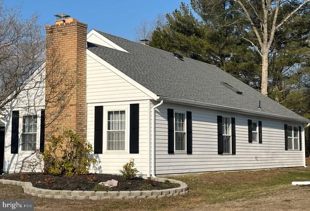 view of side of home with a lawn