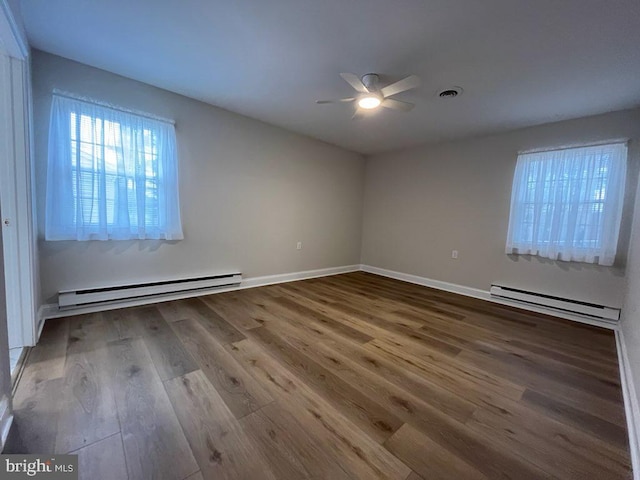 spare room with ceiling fan, hardwood / wood-style flooring, and a baseboard radiator