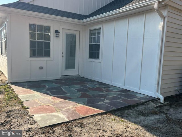 view of exterior entry with a patio