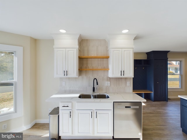 kitchen featuring white cabinetry, sink, light stone counters, and dishwasher