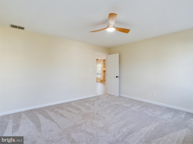 carpeted empty room featuring ceiling fan