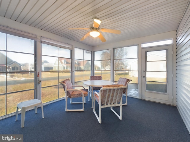 sunroom featuring ceiling fan