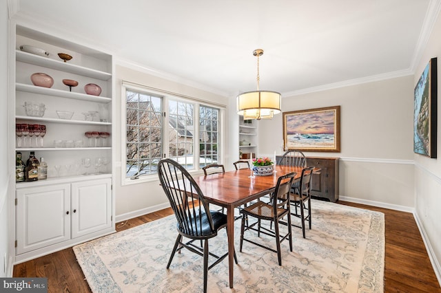 dining area with crown molding, dark hardwood / wood-style floors, and built in shelves