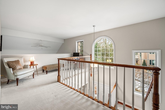 hallway featuring light colored carpet and vaulted ceiling