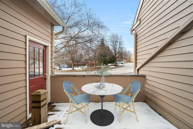 view of snow covered back of property