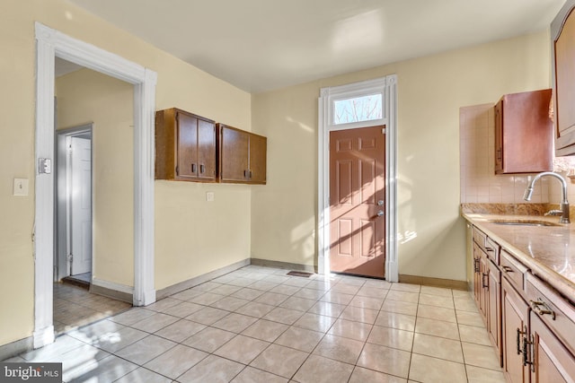 kitchen with sink, light tile patterned floors, and decorative backsplash