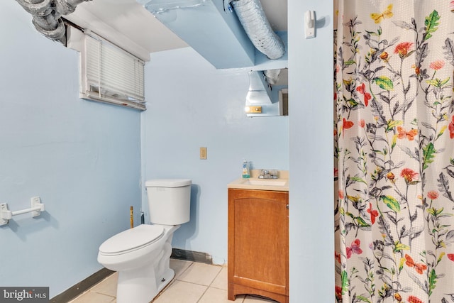 bathroom with vanity, toilet, and tile patterned floors