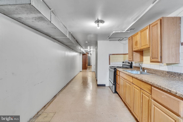 kitchen featuring sink, light brown cabinetry, tasteful backsplash, and stainless steel electric stove