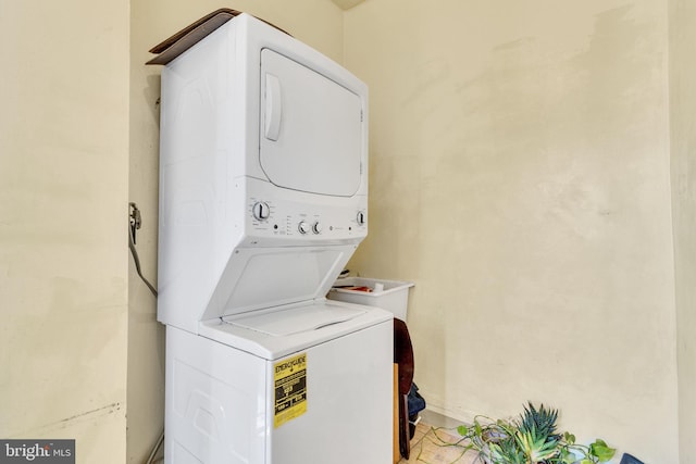 laundry room with stacked washer and dryer