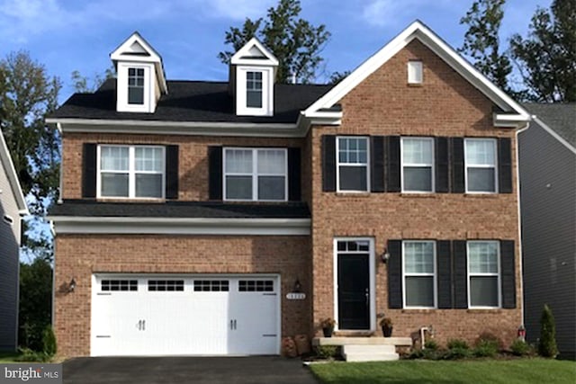 view of front of house featuring a front lawn and a garage