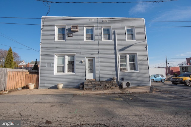 view of property with entry steps and fence