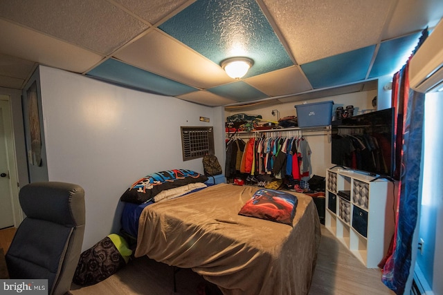 bedroom with a closet and a wall unit AC