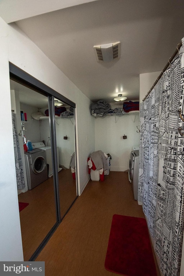 bathroom featuring washing machine and clothes dryer