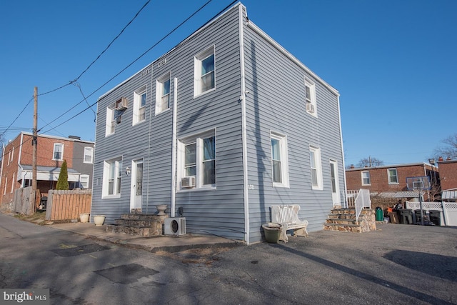 view of side of home featuring cooling unit and ac unit