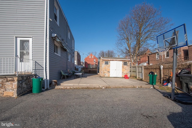 view of home's exterior with a patio area and a storage shed