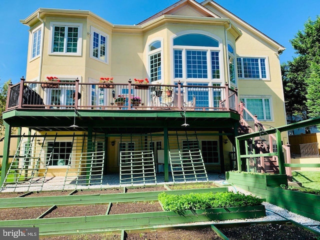 back of house featuring a wooden deck