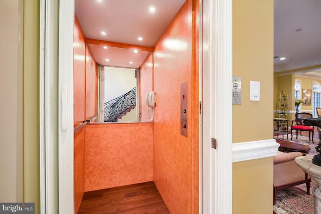 hallway featuring elevator and dark hardwood / wood-style flooring