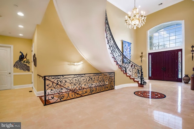 entrance foyer featuring a towering ceiling and a chandelier