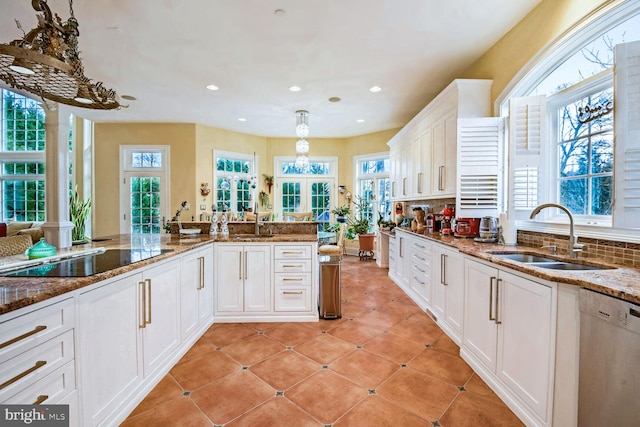 kitchen featuring stone countertops, sink, white cabinets, white dishwasher, and black electric cooktop