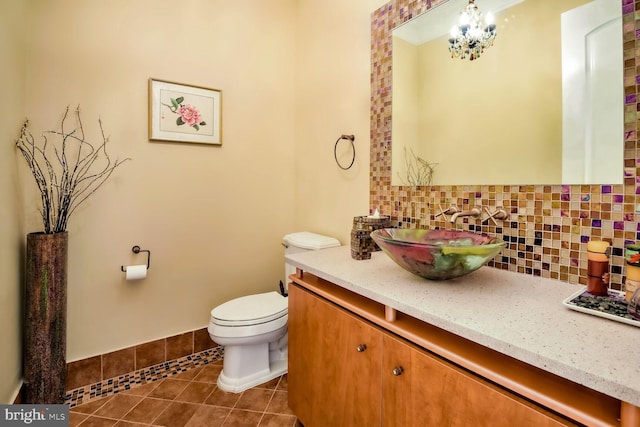 bathroom featuring vanity, backsplash, tile patterned floors, and toilet