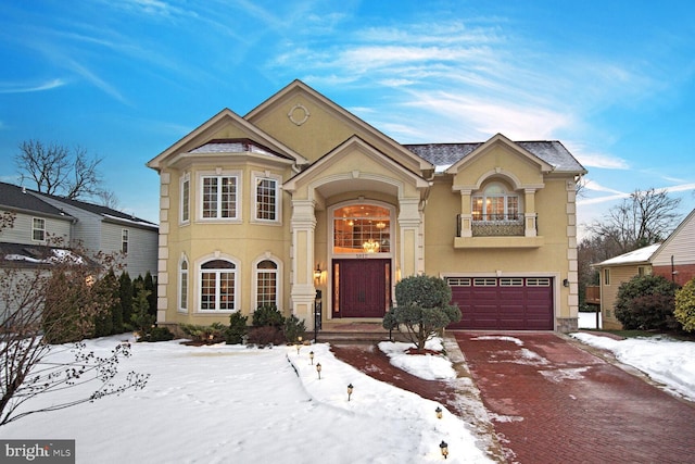 view of front property with a garage and a balcony