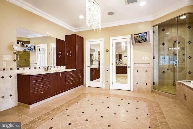 bathroom with walk in shower, tile patterned floors, tile walls, ornamental molding, and vanity