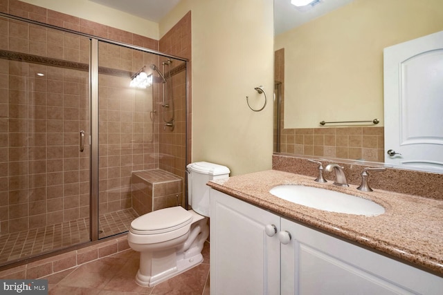 bathroom with vanity, toilet, a shower with shower door, and tile patterned flooring