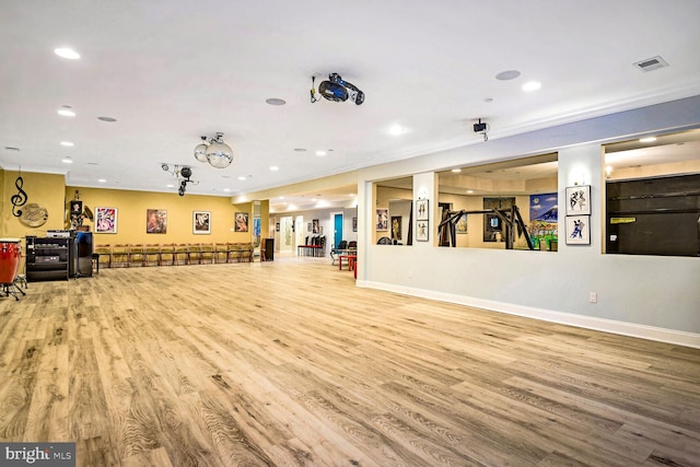 exercise room with wood-type flooring