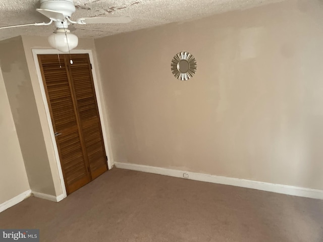 unfurnished bedroom with ceiling fan, carpet floors, a closet, and a textured ceiling