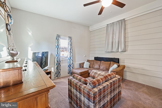 living room with ceiling fan and carpet floors