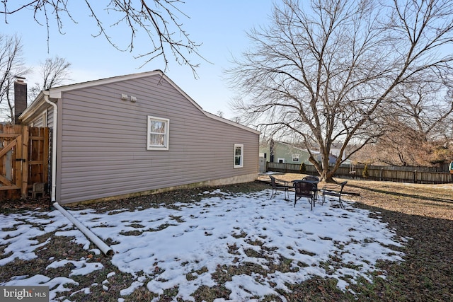 snow covered property with a fire pit