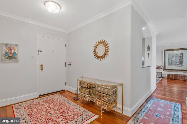 entrance foyer with hardwood / wood-style flooring and crown molding