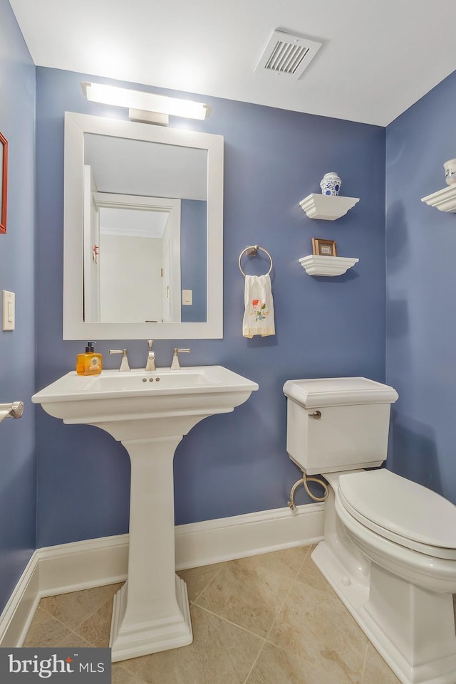 bathroom with toilet and tile patterned flooring