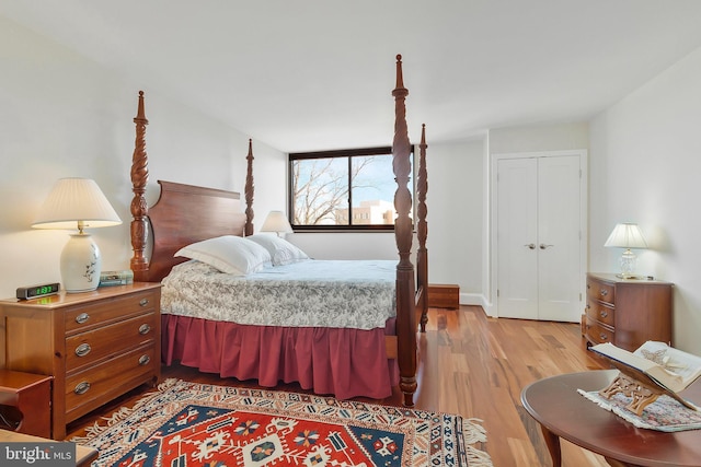 bedroom featuring light wood-type flooring and a closet