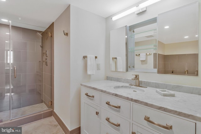 bathroom with tile patterned floors, an enclosed shower, and vanity