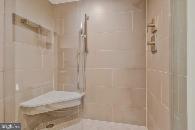 bathroom with a tile shower