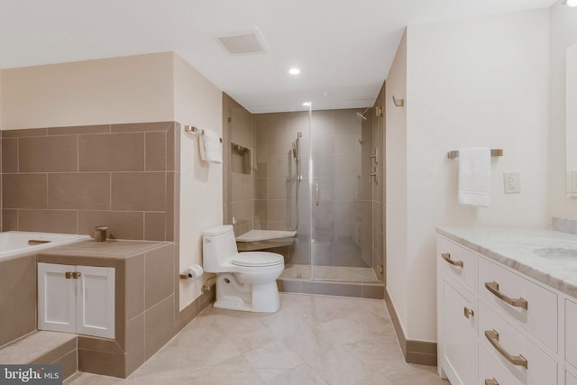 bathroom with toilet, vanity, and walk in shower